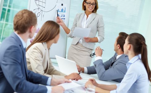 Working seminar Confident businesswoman explaining something to colleagues at meeting